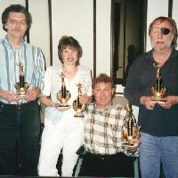Al D, Annette, Mike M, and Richard, holding trophies.